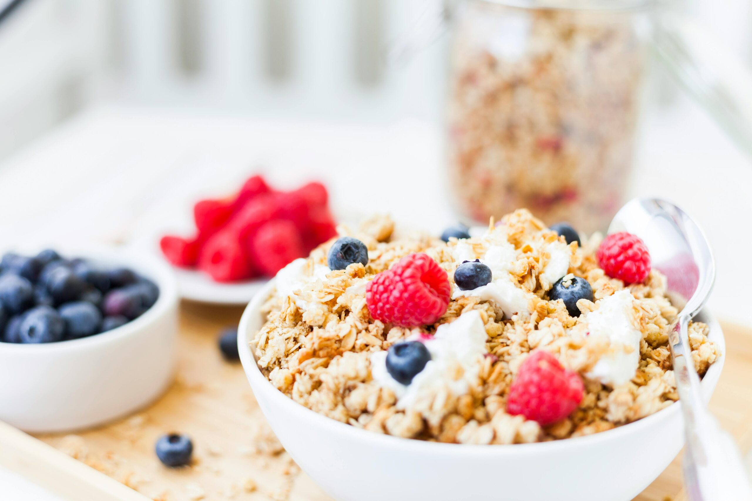 pexels-photo-30529077-30529077 Healthy granola breakfast bowl topped with fresh raspberries and blueberries.